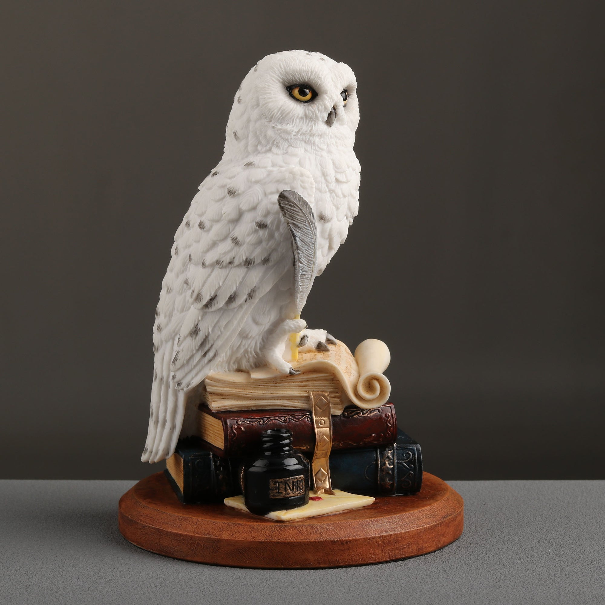 Snowy Owl Scripting On Top Of
Stack Of Books Statue