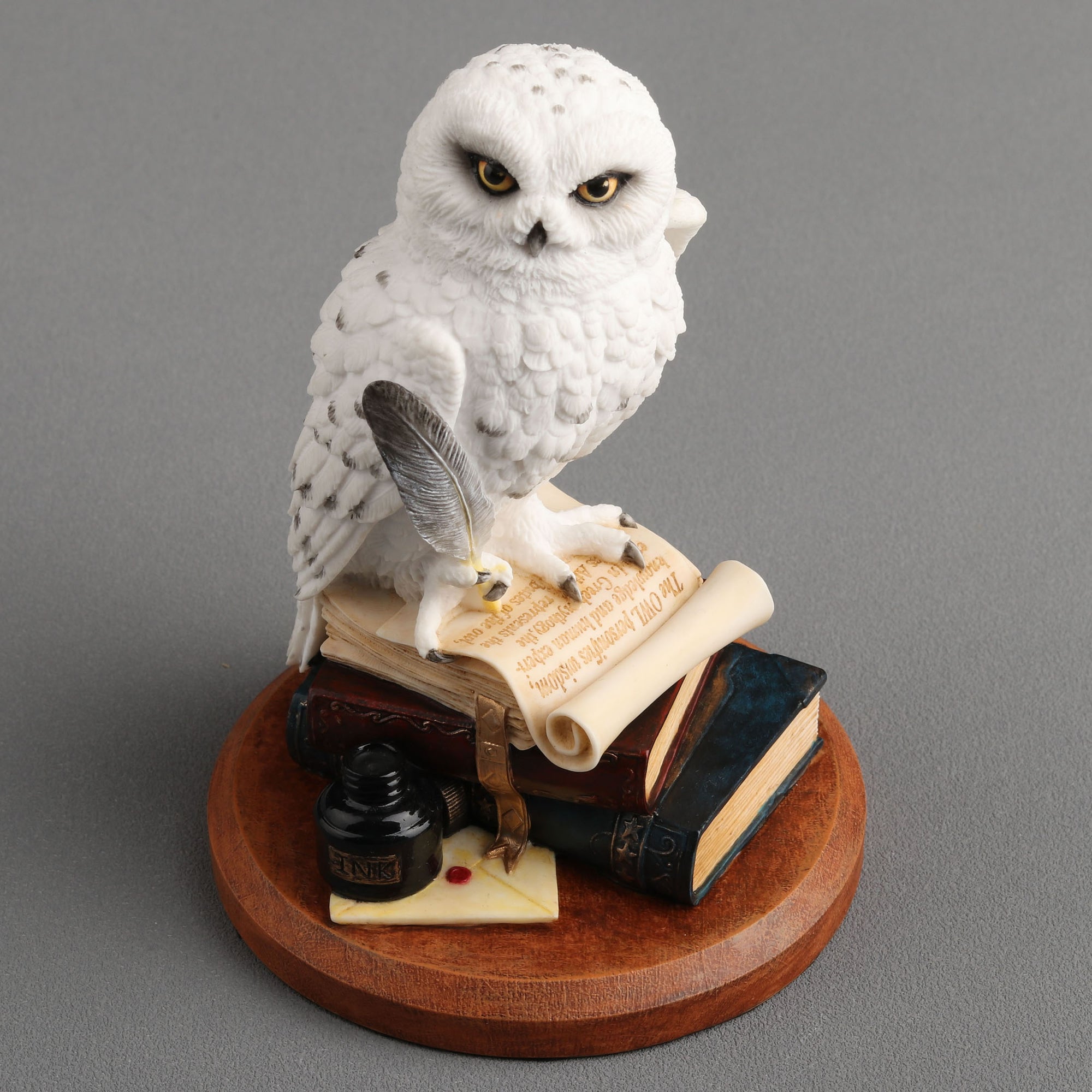 Snowy Owl Scripting On Top Of
Stack Of Books Statue